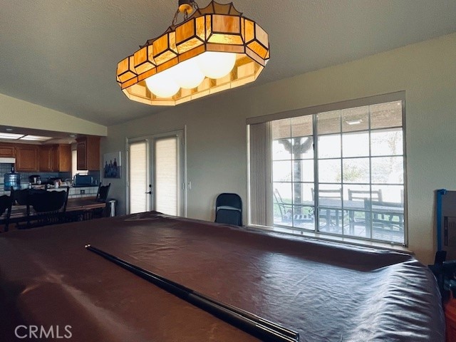 game room with vaulted ceiling and pool table