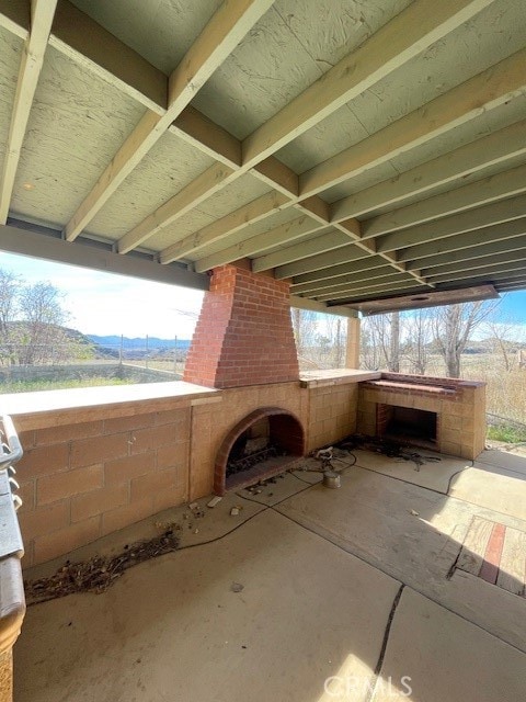 view of patio with an outdoor brick fireplace