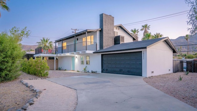 view of front of home featuring a mountain view and a balcony