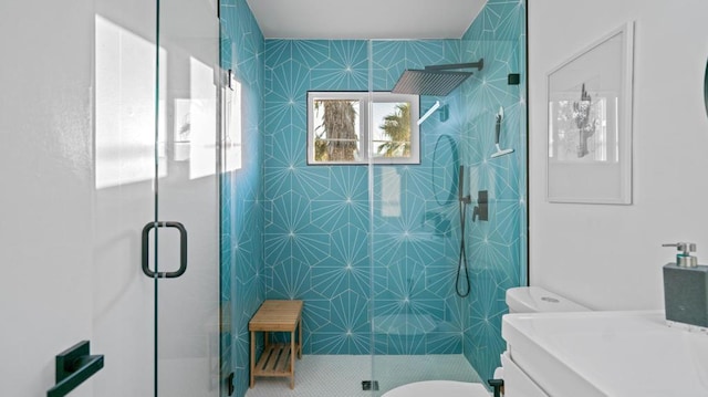 bathroom featuring vanity, toilet, and a shower with shower door