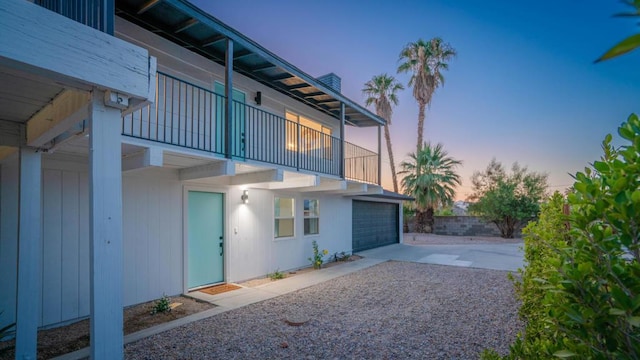 exterior space featuring a garage and a balcony