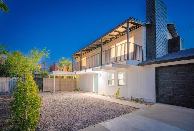 rear view of property with a balcony