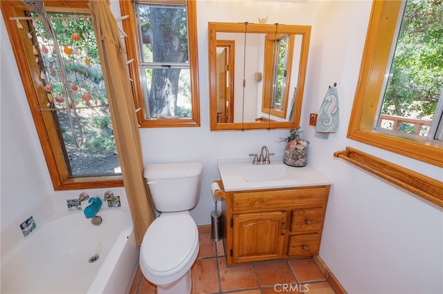 bathroom with vanity, a tub, tile patterned floors, and toilet