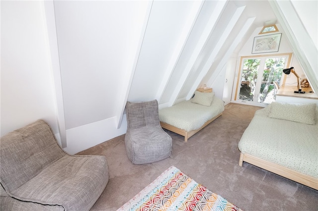 living area featuring carpet and vaulted ceiling