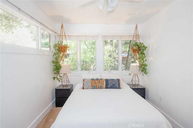 bedroom featuring multiple windows, carpet floors, and ceiling fan