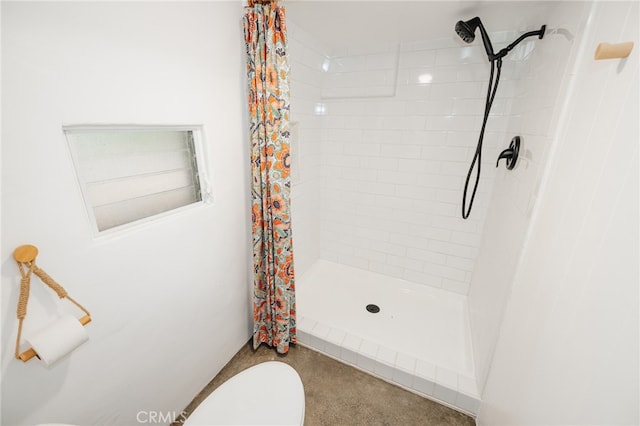 bathroom featuring toilet and walk in shower