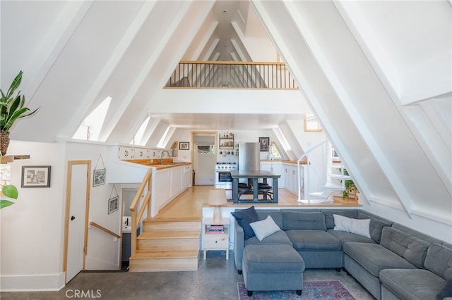 living room featuring beam ceiling and high vaulted ceiling