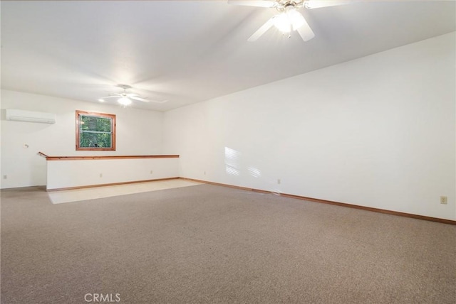 carpeted empty room featuring a wall mounted air conditioner, ceiling fan, and baseboards