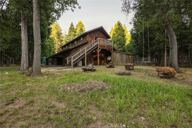 back of house featuring a deck and stairs