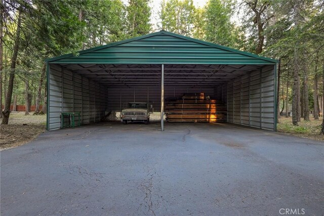 view of parking / parking lot featuring a carport