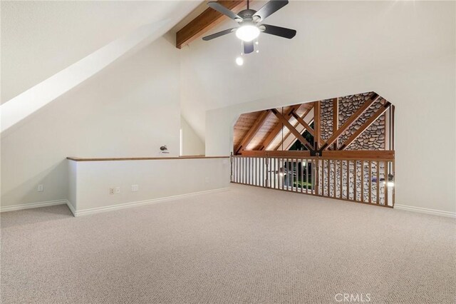 additional living space with ceiling fan, lofted ceiling with beams, and carpet floors