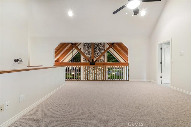 additional living space with ceiling fan, carpet floors, high vaulted ceiling, and baseboards