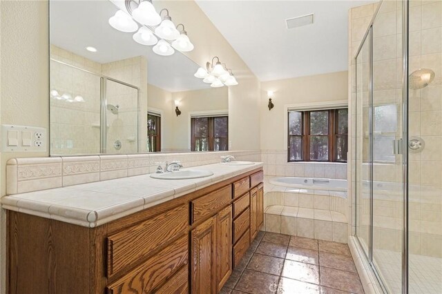 bathroom featuring vanity, shower with separate bathtub, and tile patterned flooring