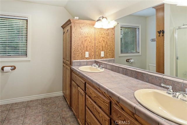 bathroom featuring double vanity, tile patterned flooring, a sink, and toilet