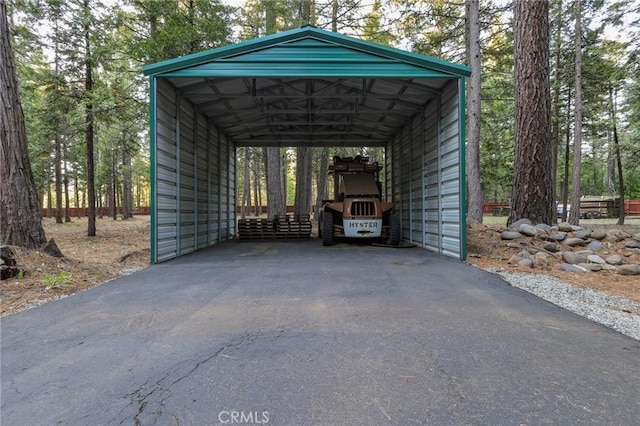 view of parking featuring driveway and a detached carport