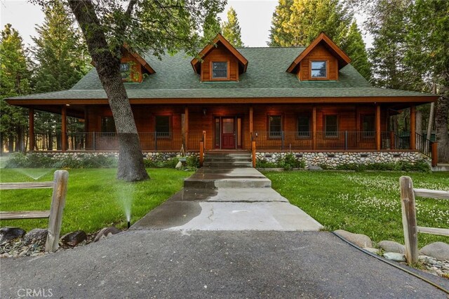 view of front of property with a front yard and a porch