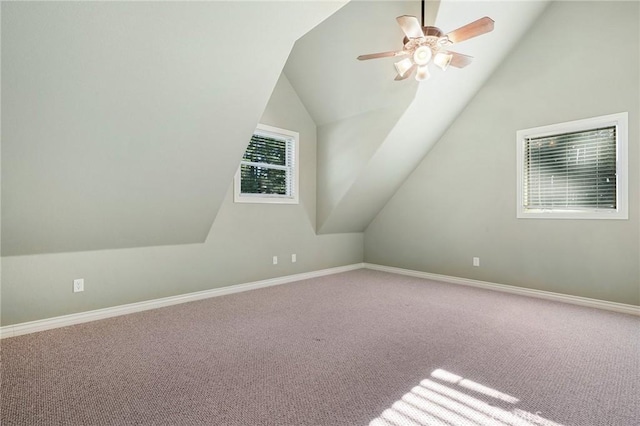 additional living space with a ceiling fan, lofted ceiling, carpet flooring, and baseboards