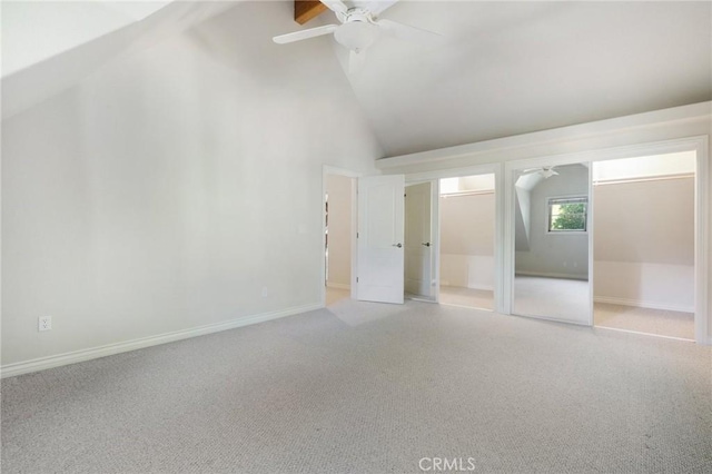 unfurnished bedroom featuring high vaulted ceiling, light colored carpet, ceiling fan, and baseboards