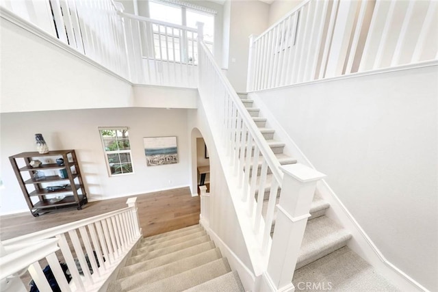 stairway with hardwood / wood-style flooring