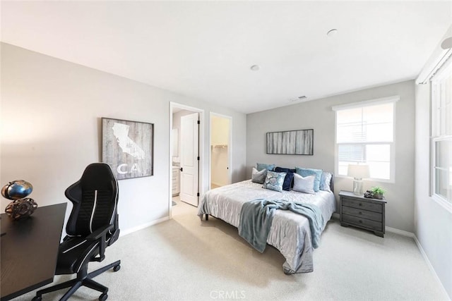 carpeted bedroom featuring ensuite bathroom