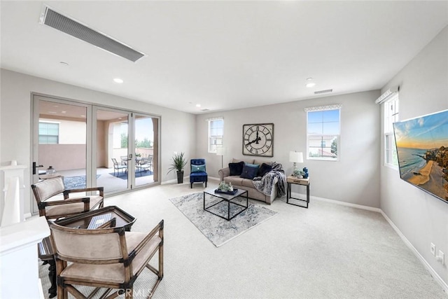 carpeted living room with french doors and a wealth of natural light