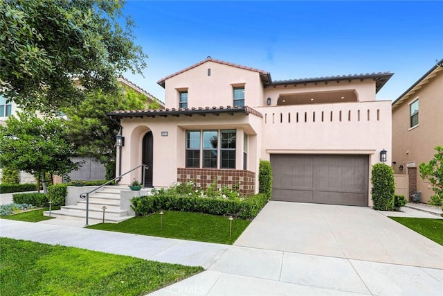 mediterranean / spanish-style house featuring a garage and a front lawn