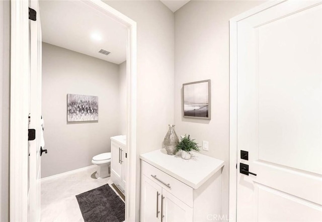 bathroom featuring vanity and toilet