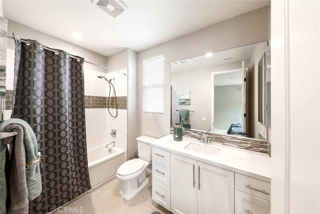 full bathroom featuring vanity, toilet, and tiled shower / bath