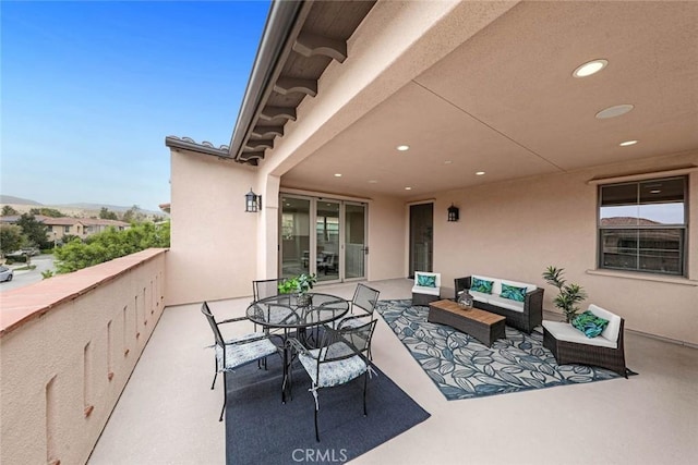 view of patio featuring an outdoor hangout area and a balcony