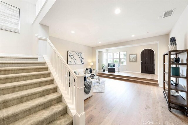 stairway with hardwood / wood-style floors