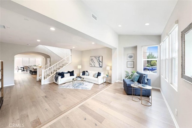 living room featuring vaulted ceiling and hardwood / wood-style flooring