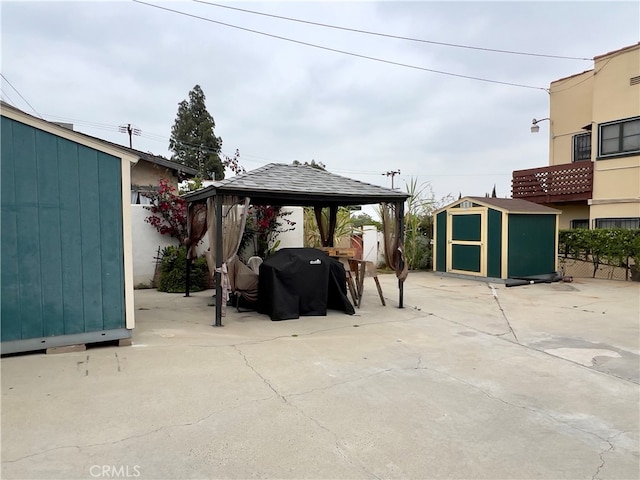 view of patio featuring a gazebo, area for grilling, and a shed