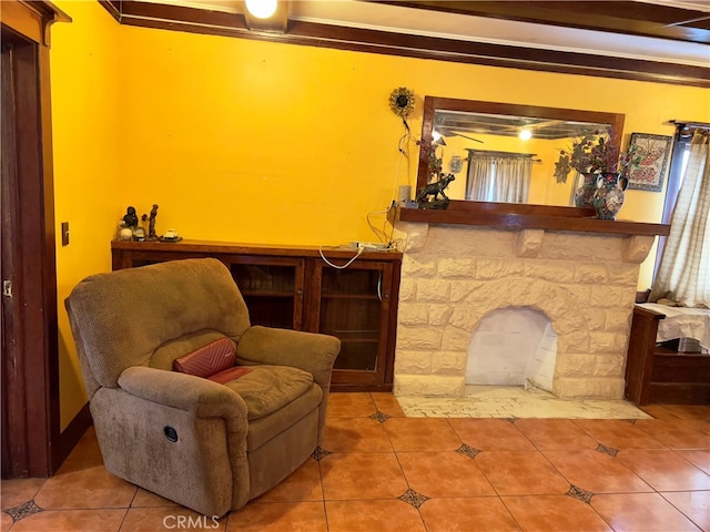 sitting room featuring a fireplace, tile patterned floors, and crown molding