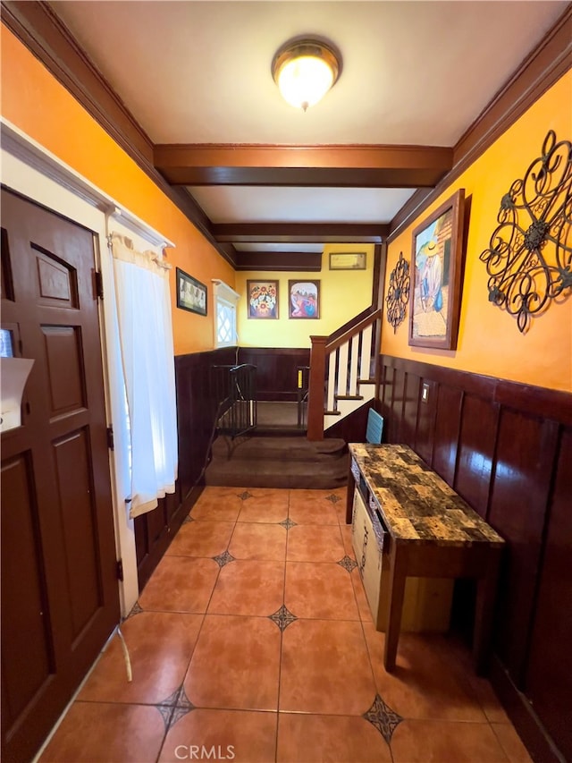 hallway with beam ceiling and tile patterned floors