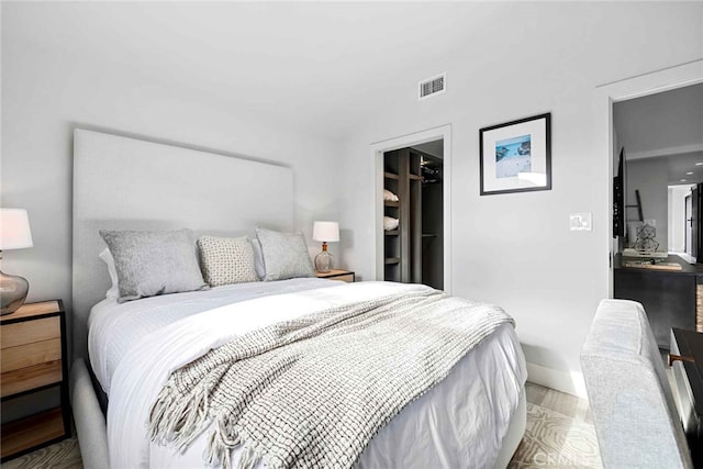 bedroom featuring a spacious closet and a closet