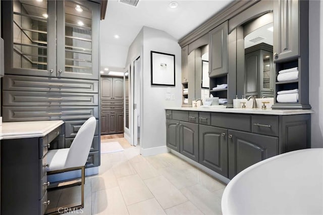 bathroom featuring a bath, tile patterned flooring, and vanity