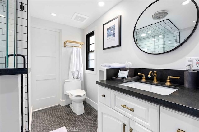 bathroom with toilet, walk in shower, tile patterned floors, and vanity