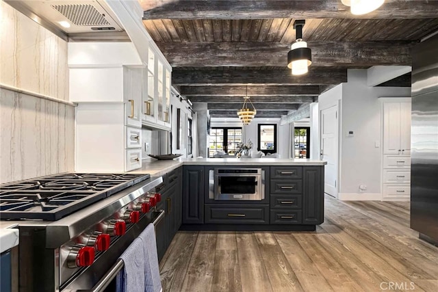 kitchen with beamed ceiling, white cabinetry, hanging light fixtures, wood ceiling, and stainless steel appliances