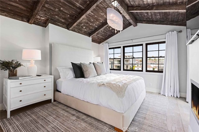 bedroom featuring vaulted ceiling with beams, wood-type flooring, and wood ceiling