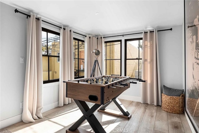 game room with light hardwood / wood-style floors