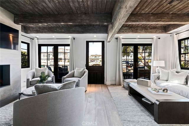 living room with light wood-type flooring, wood ceiling, beam ceiling, and french doors