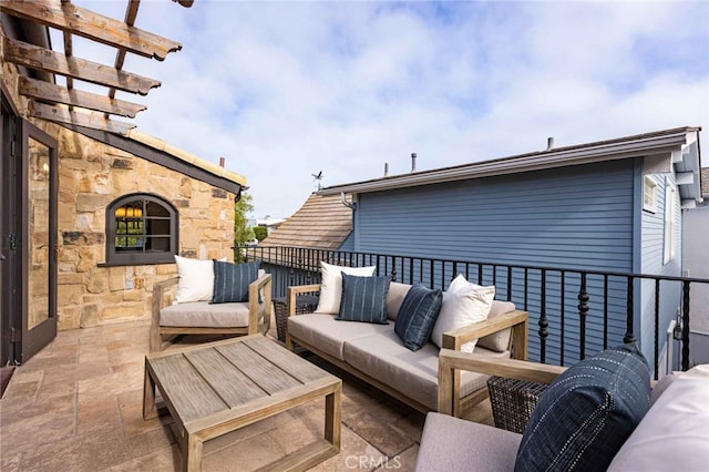 view of patio featuring a balcony and outdoor lounge area