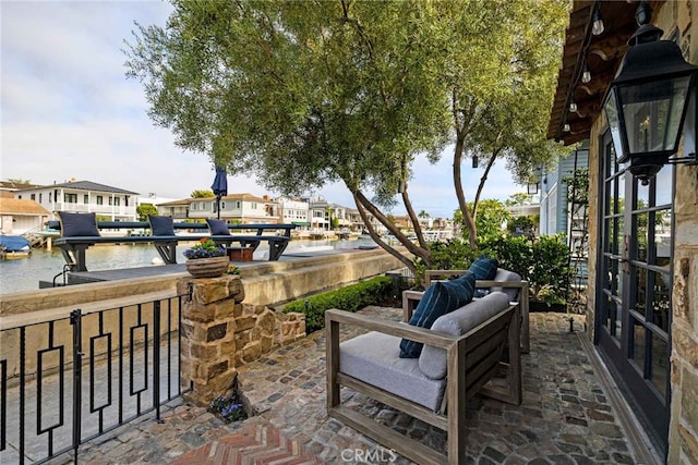 view of patio with french doors and a water view