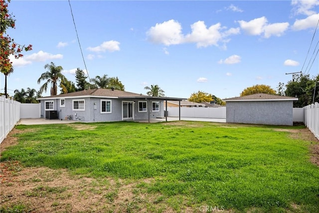 rear view of house with a yard, a patio, and central air condition unit