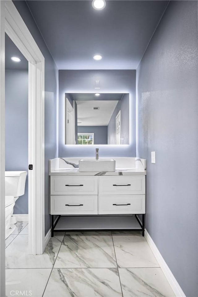 bathroom featuring vanity and toilet