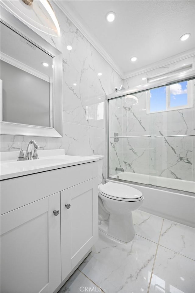 full bathroom with vanity, toilet, bath / shower combo with glass door, and crown molding