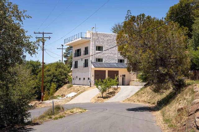 view of front of home with a balcony and a garage