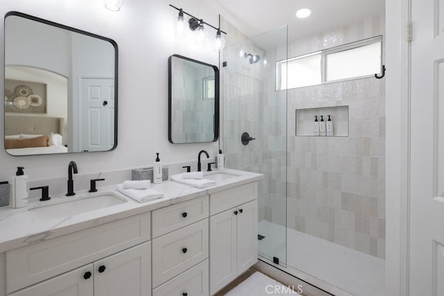 bathroom featuring an enclosed shower and vanity