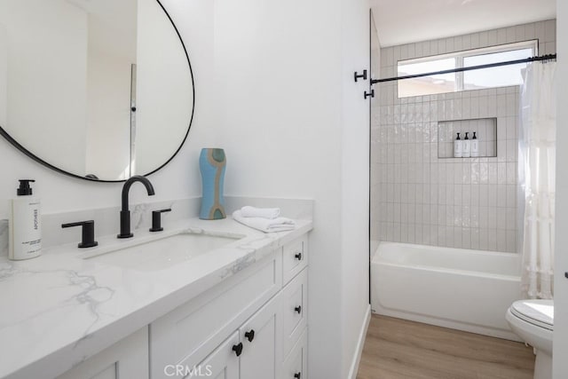 full bathroom with shower / bath combo with shower curtain, wood-type flooring, toilet, and vanity