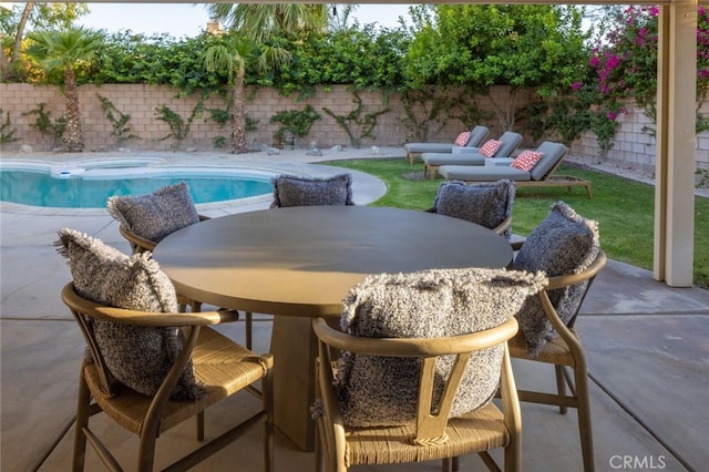 view of pool featuring a patio and an in ground hot tub